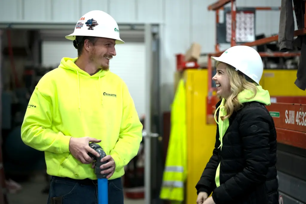 Two team member talking in a warehouse.